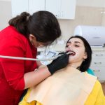 patient receiving professional dental checkup and teeth cleaning for better oral health